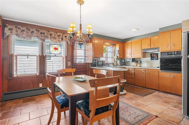 dining area featuring a baseboard heating unit and an inviting chandelier