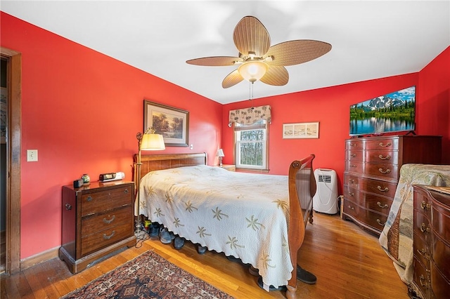 bedroom featuring wood finished floors and a ceiling fan