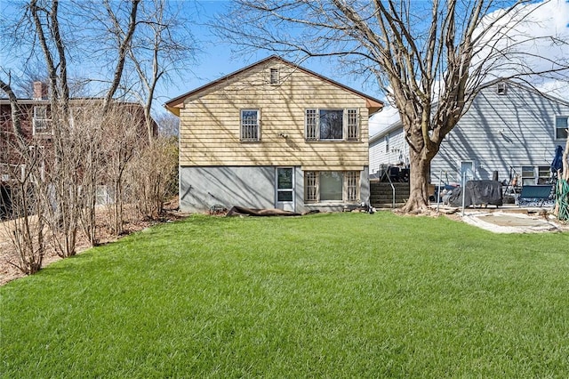 rear view of property with a yard