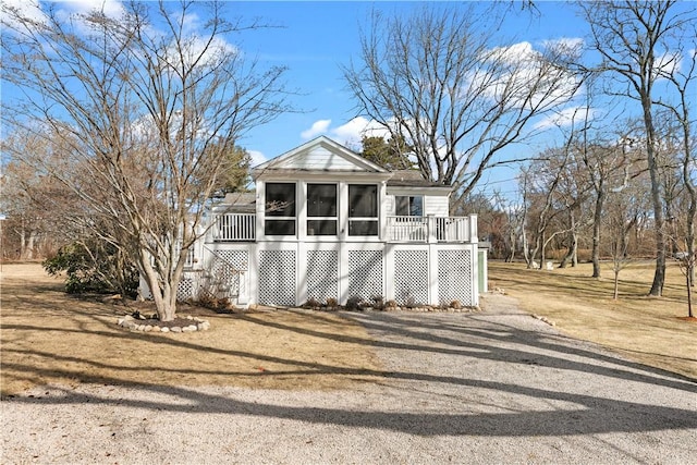 view of front of house with stairs and a sunroom