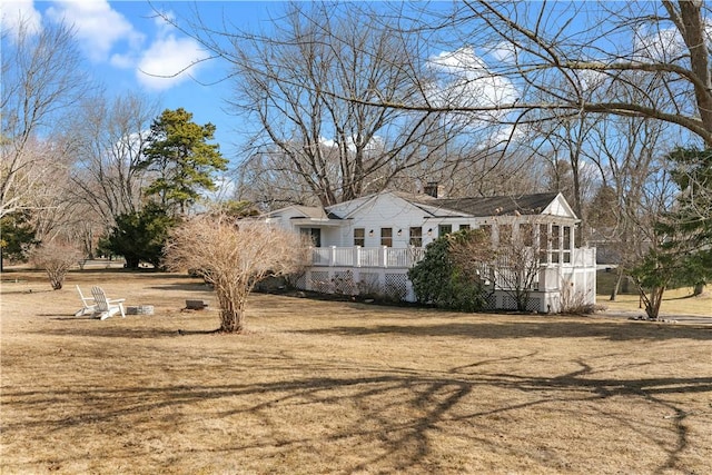 view of side of property with a yard and a deck