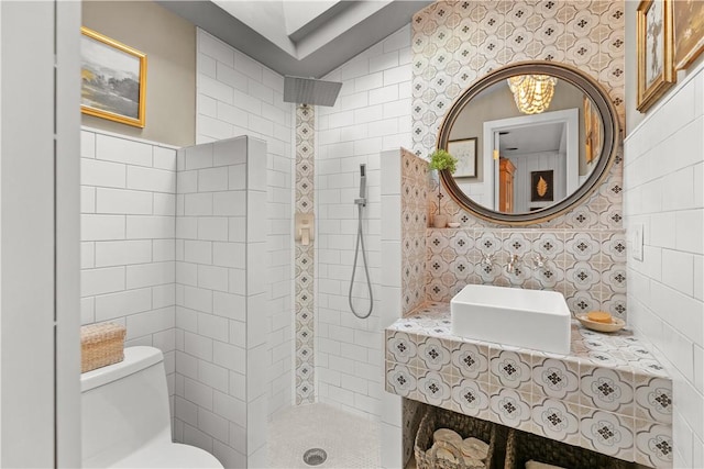 full bath featuring toilet, a walk in shower, tasteful backsplash, and a sink