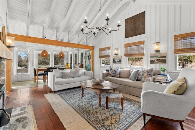 living area featuring hardwood / wood-style flooring, beamed ceiling, a notable chandelier, and high vaulted ceiling