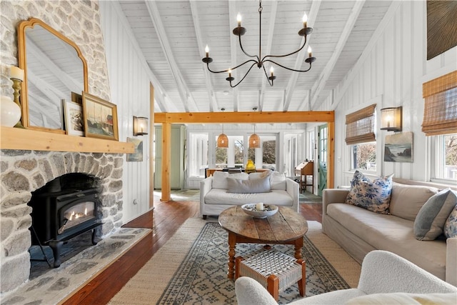 living area with beam ceiling, a notable chandelier, and hardwood / wood-style flooring