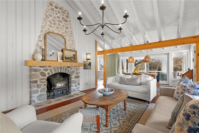 living area with lofted ceiling with beams, a notable chandelier, and wood finished floors