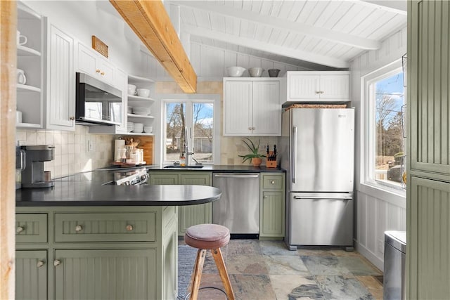 kitchen with open shelves, dark countertops, appliances with stainless steel finishes, and green cabinets