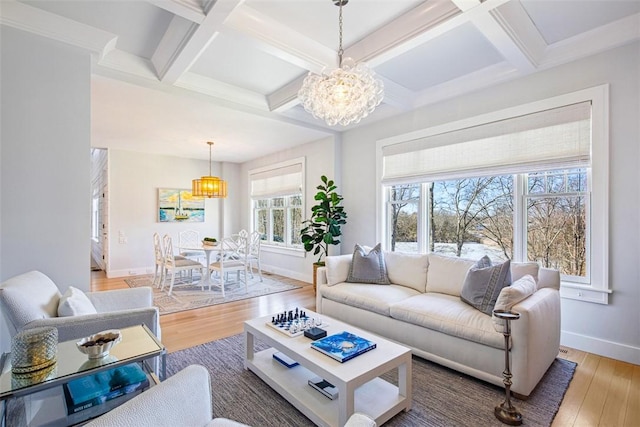 living room with coffered ceiling, light wood-type flooring, and baseboards