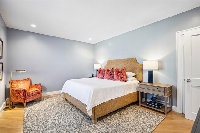 bedroom with recessed lighting, baseboards, and wood finished floors