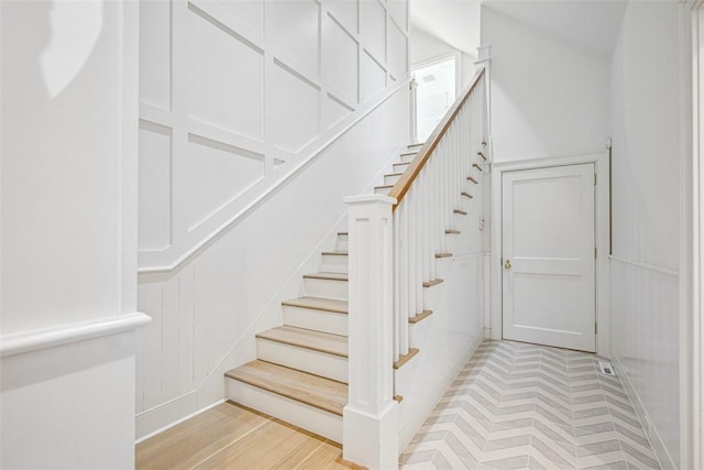 stairway with wood finished floors