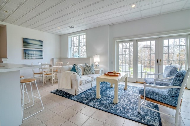 living area with tile patterned flooring, recessed lighting, french doors, and visible vents