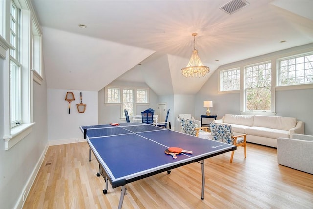 playroom featuring lofted ceiling, baseboards, visible vents, and light wood-type flooring