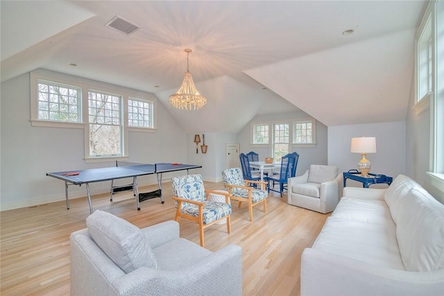 playroom with vaulted ceiling, baseboards, visible vents, and light wood finished floors