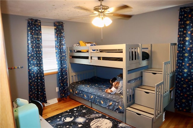 bedroom with a ceiling fan and wood finished floors