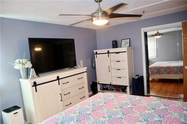 bedroom with wood finished floors and a ceiling fan