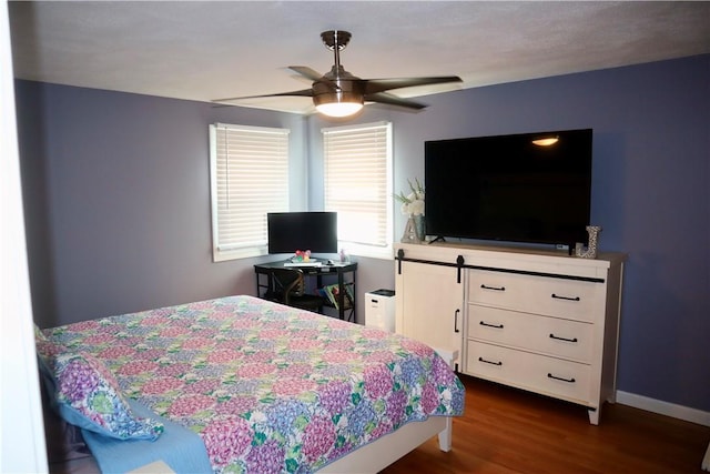 bedroom with baseboards, dark wood-style flooring, and ceiling fan