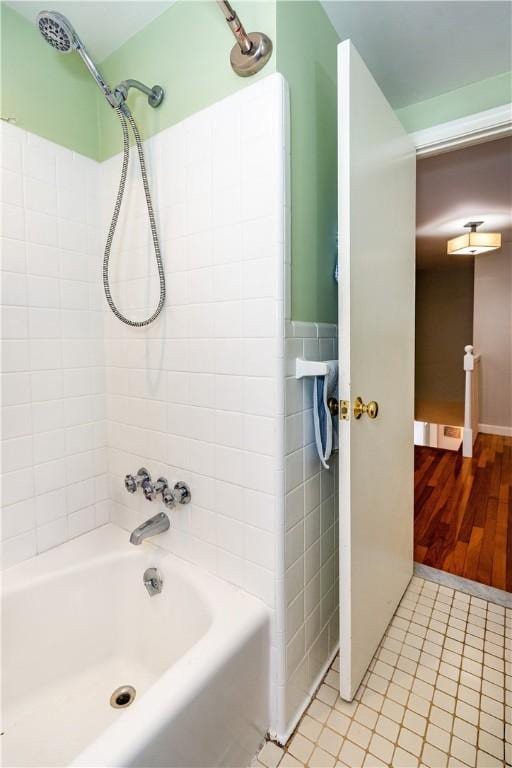 full bathroom with tile patterned floors, tile walls, and shower / tub combination