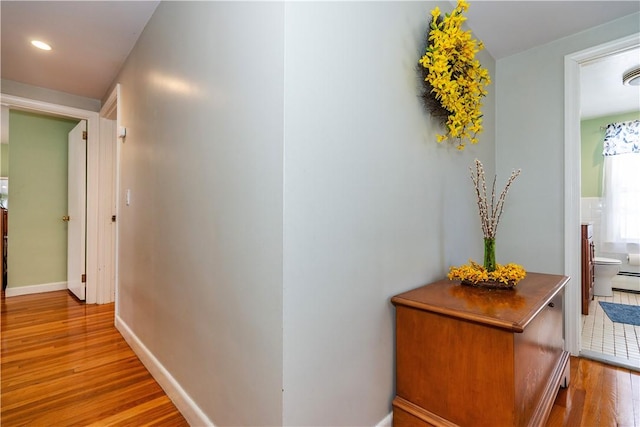 hallway with recessed lighting, wood finished floors, and baseboards