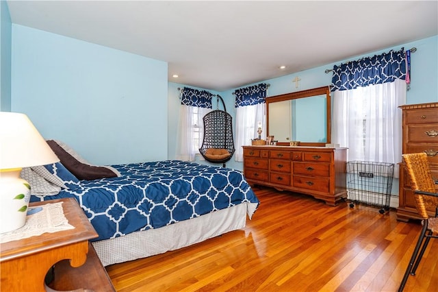 bedroom featuring recessed lighting and wood finished floors