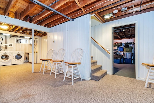 below grade area featuring carpet flooring, stairs, and washing machine and clothes dryer