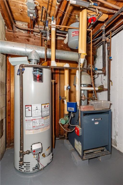 utility room featuring gas water heater and a heating unit