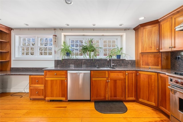 kitchen featuring appliances with stainless steel finishes, a sink, open shelves, recessed lighting, and brown cabinetry
