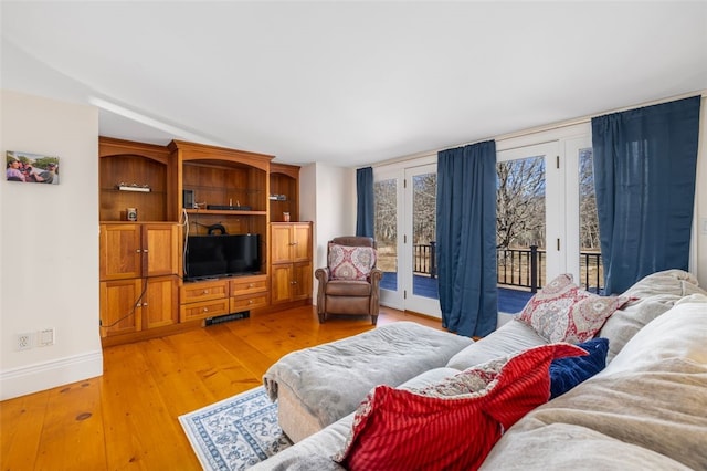 living room featuring baseboards and light wood-style flooring