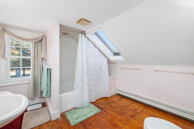 full bathroom featuring baseboard heating, a skylight, wood finished floors, lofted ceiling, and toilet