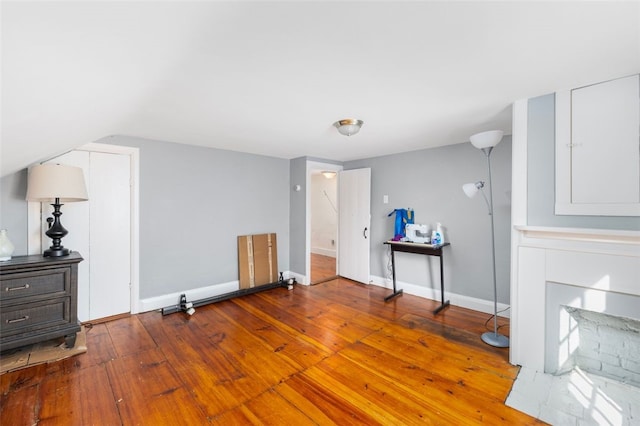 bonus room with wood-type flooring and baseboards