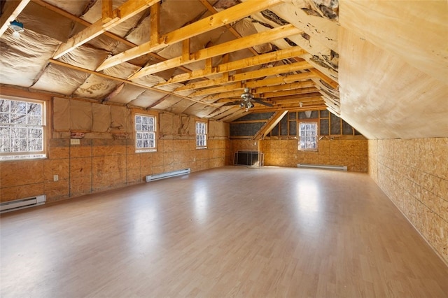 bonus room with a baseboard radiator, wood finished floors, plenty of natural light, and lofted ceiling