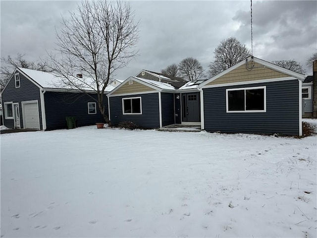 ranch-style home with a detached garage and an outbuilding