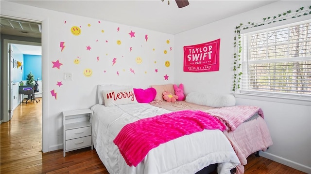 bedroom featuring wood finished floors, baseboards, and ceiling fan