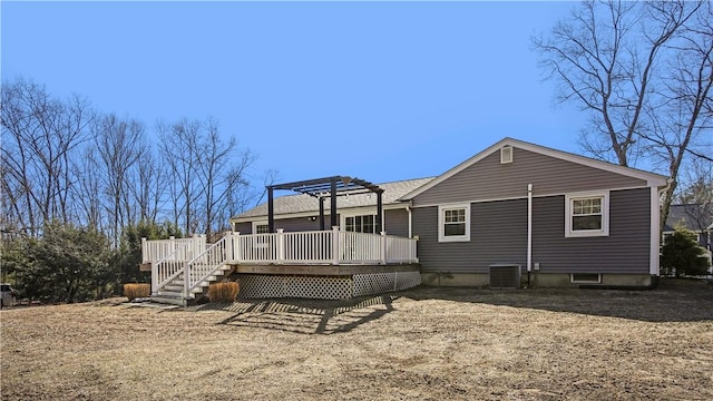 back of property featuring a wooden deck and a pergola