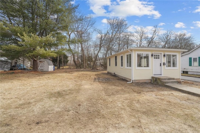 exterior space featuring an outbuilding and a storage shed