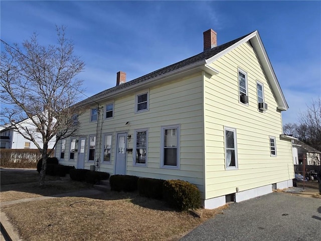 rear view of house featuring a chimney