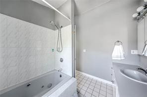 bathroom featuring tile patterned flooring, shower / tub combination, and baseboards