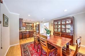 dining area with light wood finished floors, recessed lighting, and baseboards