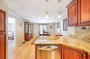 kitchen with decorative backsplash, a peninsula, light wood-style floors, hanging light fixtures, and stainless steel dishwasher