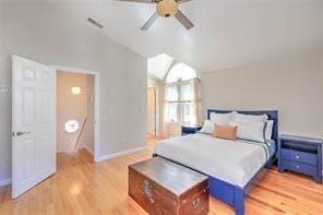 bedroom with visible vents, lofted ceiling, light wood-style floors, and baseboards