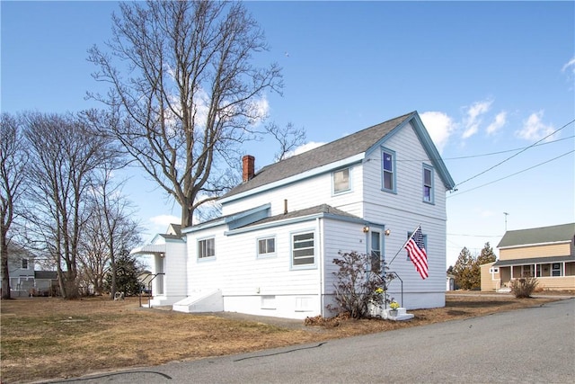 view of property exterior featuring a chimney