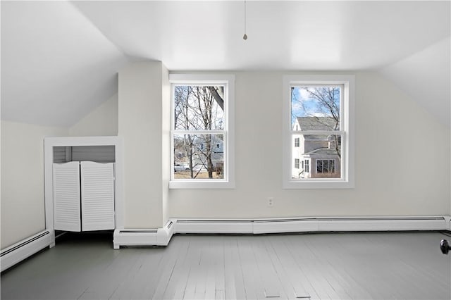 bonus room featuring a baseboard heating unit, lofted ceiling, wood finished floors, and a baseboard radiator