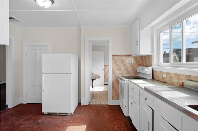 kitchen with white appliances, backsplash, light countertops, and white cabinetry