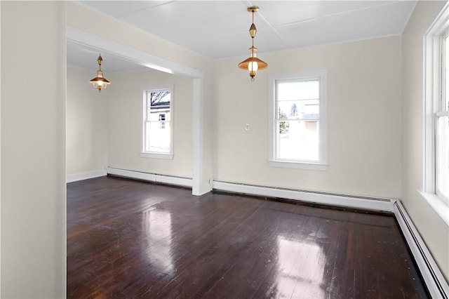 empty room featuring hardwood / wood-style floors and baseboard heating