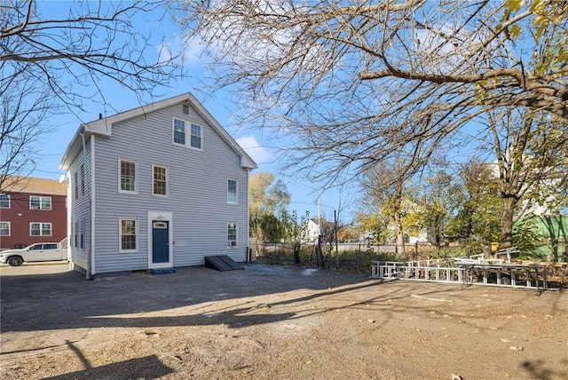 rear view of property with fence