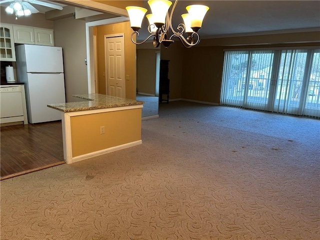 kitchen featuring a kitchen island, glass insert cabinets, light stone counters, white appliances, and white cabinetry