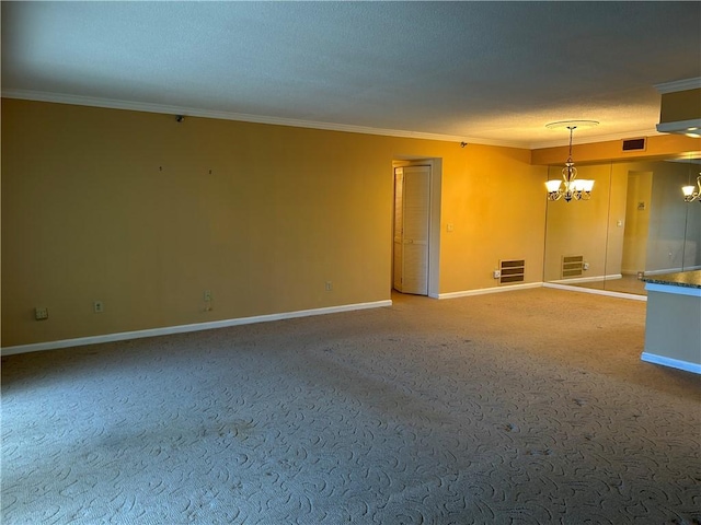 empty room featuring a notable chandelier, baseboards, visible vents, and ornamental molding