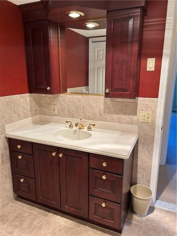 bathroom featuring vanity, tile walls, a wainscoted wall, and tile patterned floors