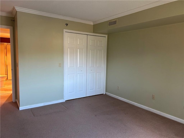 unfurnished bedroom with visible vents, baseboards, crown molding, and carpet