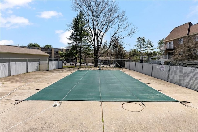 community pool featuring a patio and fence