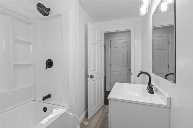 full bathroom with vanity, wood finished floors, and washtub / shower combination