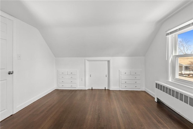 bonus room featuring baseboards, radiator, and dark wood-style floors